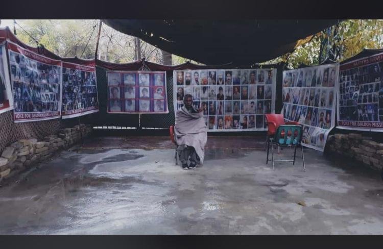 Atrocities By Pakistan Army:  Mama Qadeer Baloch who is a Human Rights Activist and, Vice President of NGO Voice of Baloch Missing Persons (VBMP) sitting with pictures of Some of the Baloch youth who were disappeared by Pakistan Army 