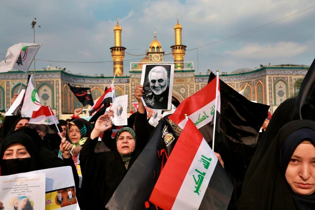 ran threatens Tel Aviv, US bases in Middle East after killing of Soleimani: Shiite Muslims demonstrate over the US airstrike that killed Iranian Revolutionary Guard Gen. Qassem Soleimani, in the posters, in Karbala, Iraq, Jan. 4, 2020 (AP Photo/Khalid Mohammed)