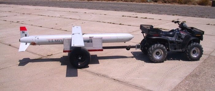 An Affordable Weapon System missile prototype on a trailer with its wing in the deployed state