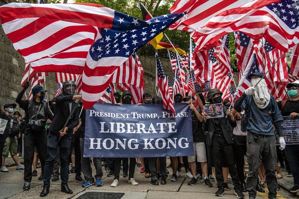 China in Focus - Hong Kong Protesters wave US Flag and hold banners  "President Trump, Please Liberate Hong Kong"