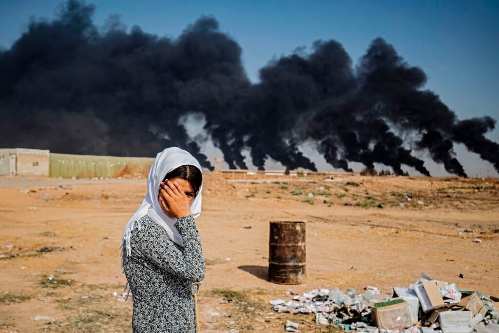 Turkey Committing War Crimes: A woman along the side of a road on the outskirts of the town of Tal Tamr near the Syrian Kurdish town of Ras al-Ain along the border with Turkey in the northeastern Hassakeh province on October 16, 2019