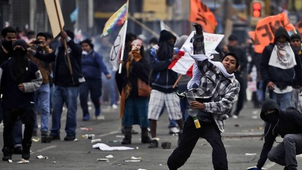 George Soros Behind The Protests In Peru To Destabilize The Region : Protester throwing some object