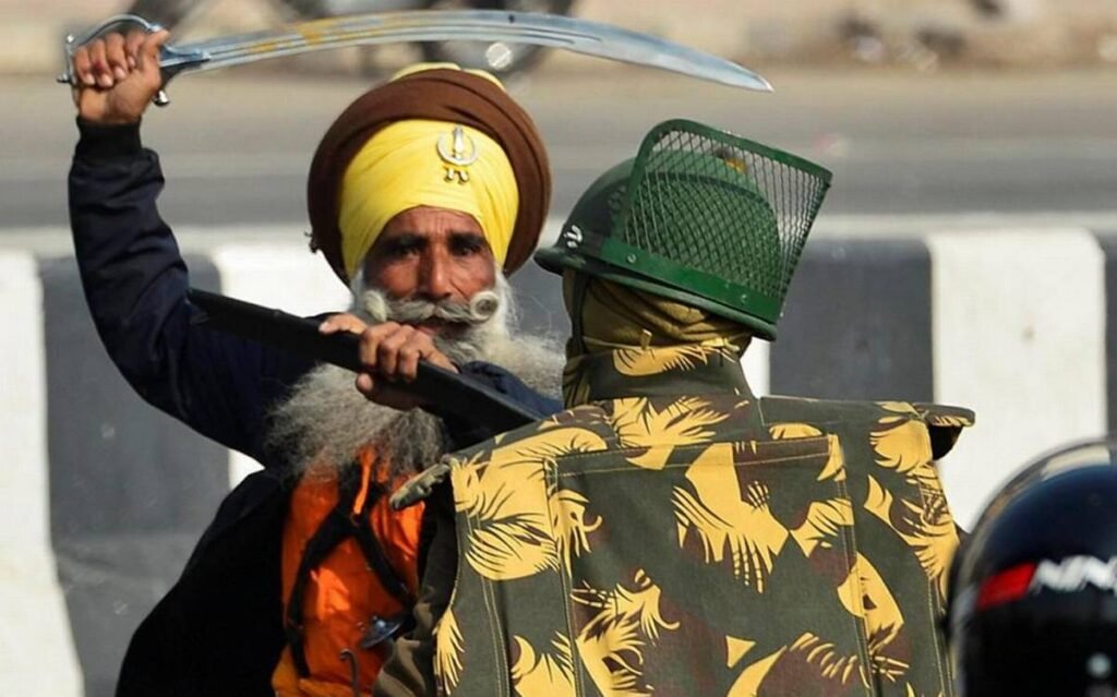 Khalistani Supporter attacking Police on duty with Sword during riots in New Delhi, India | NewsComWorld.com